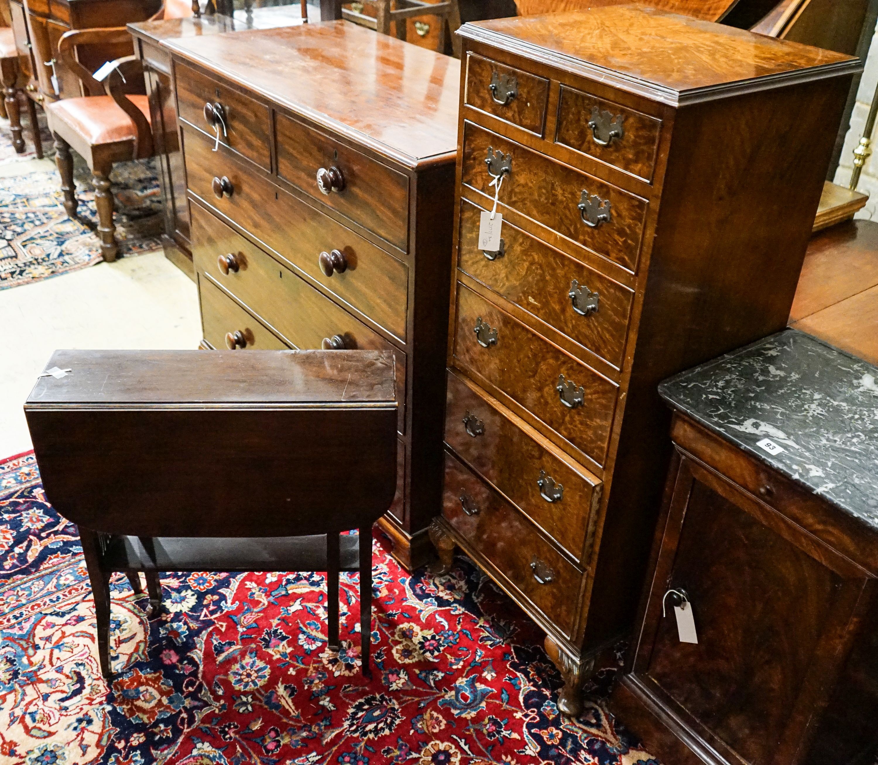 An Edwardian mahogany Sutherland table, width 61cm together with a Queen Anne style figured walnut narrow seven drawer chest